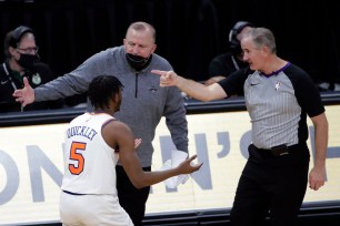 New York Knicks' Immanuel Quickley (5) and coach Tom Thibodeau argue with an official.
