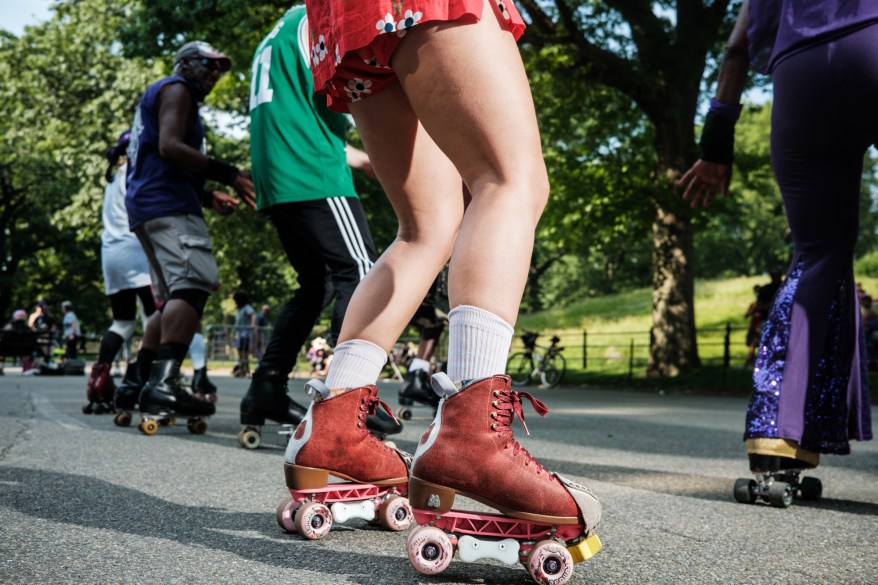 People roller skate at the Central Park Dance Skaters Association “Purple Rain” event at the Central Park Skate Circle, a popular hangout for roller skaters since 1978.