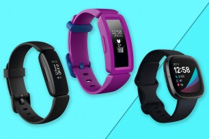 Three Fitbit watches on a blue background