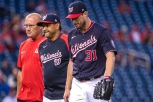 Max Scherzer walks off the field with Nationals manager Dave Martinez and a team trainer after suffering an injury just 12 pitches into his outing.