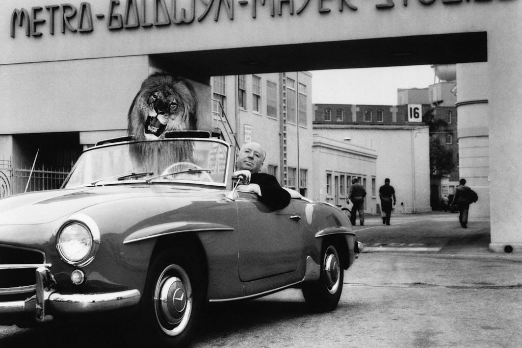 Alfred Hitchcock on the MGM studio lot in 1959 in a convertible.  