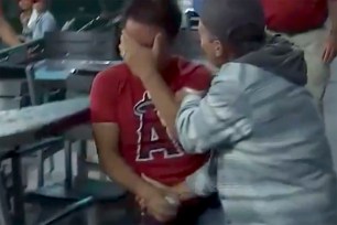 An Angels fan in pain after retrieving a foul ball.