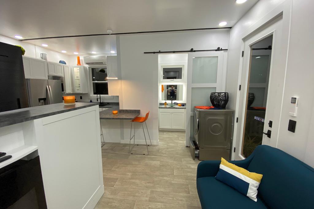 The living room is adjacent to the bathroom and laundry room.