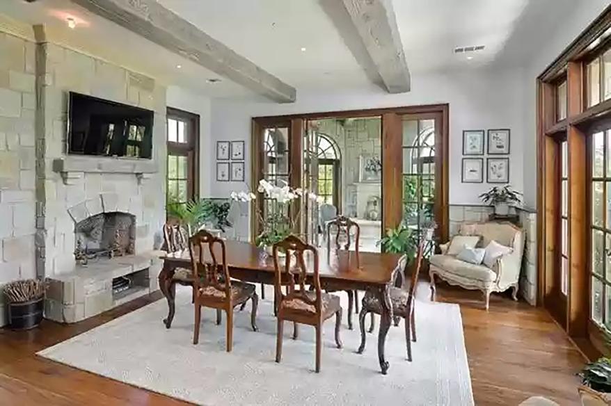 A second dining room with exposed ceiling beams is pictured.