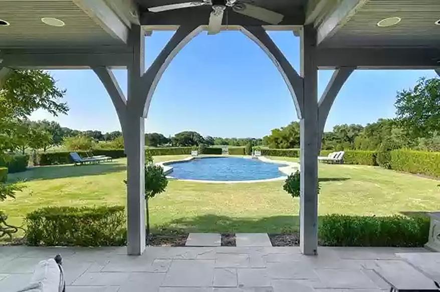 The pool is visible from under the covered patio in this picture.