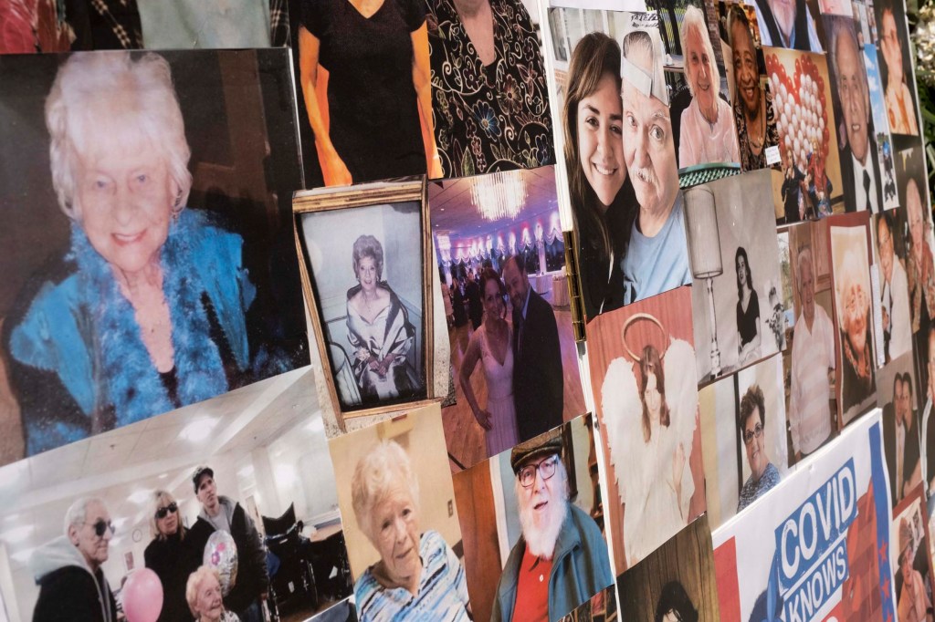 Photos of elderly nursing home patients who died during the COVID-19 pandemic at a memorial in Brooklyn on March 21, 2021.