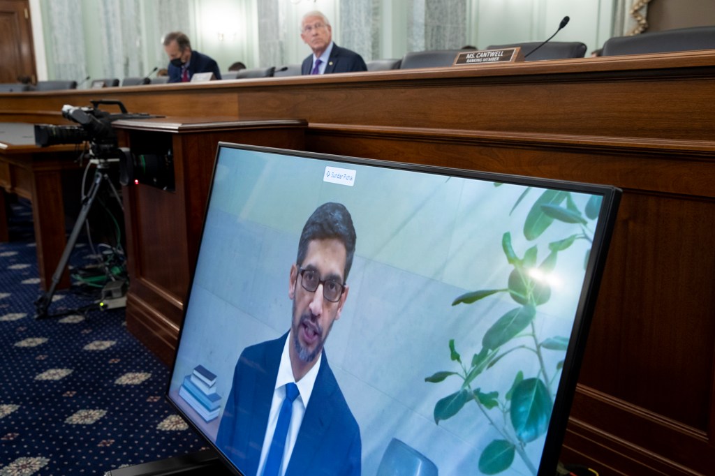 Lawmakers listen as Sundar Pichai, CEO of Alphabet and its subsidiary Google, appears on a monitor as he testifies remotely during a Senate panel hearing.