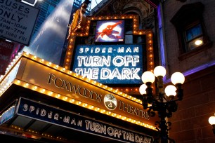 Banners advertising the Broadway play "Spiderman: Turn Off The Dark" shine in front of the Foxwoods Theater in New York December 23, 2010.