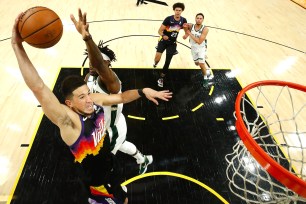 Devin Booker, who scored 31 points, goes up for a dunk during the Suns' 118-108 Game 2 win over the Bucks.