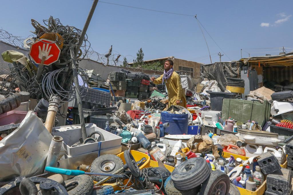 An Afghan scrap dealer sort items which were discarded by the US forces outside Bagram Air Base