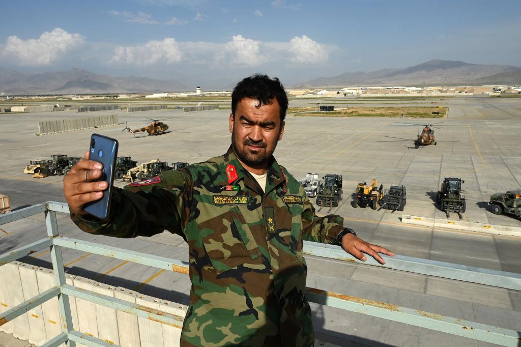 An Afghan National Army (ANA) soldier take a selfie with his mobile phone inside the Bagram US air base after all US and NATO troops left