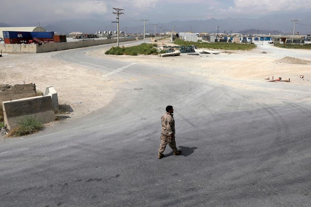 A member of the Afghan security forces walks in the sprawling Bagram air base after the American military departed