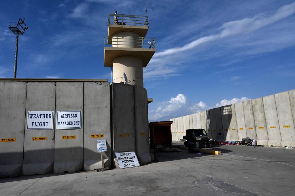 An Afghan National Army (ANA) soldier keeps a watch atop a tower inside the Bagram US air base