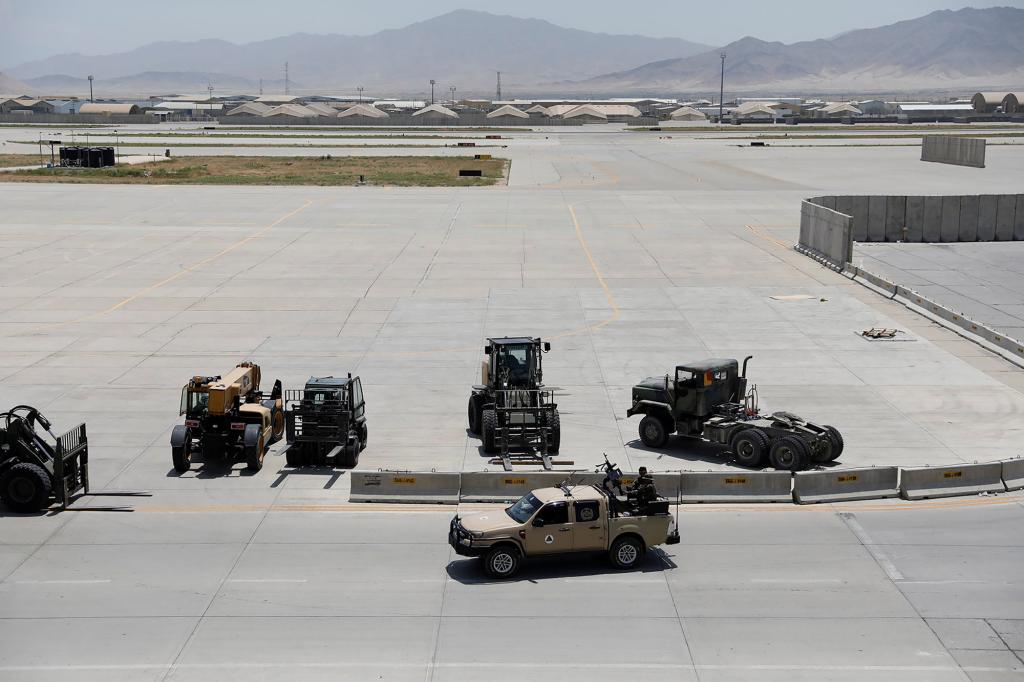 Afghan soldiers patrol in an army vehicle in Bagram U.S. air base, after American troops vacated it