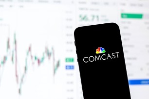 In this photo illustration a Comcast Corporation logo seen