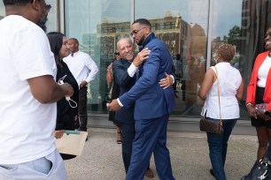 Grant Williams hugging his lawyer.