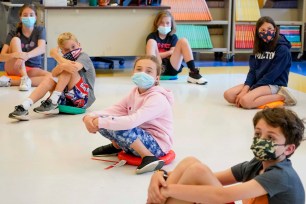 Fifth graders wearing face masks are seated at proper social distancing during a music class at the Milton Elementary School in Rye, N.Y earlier in 2021.