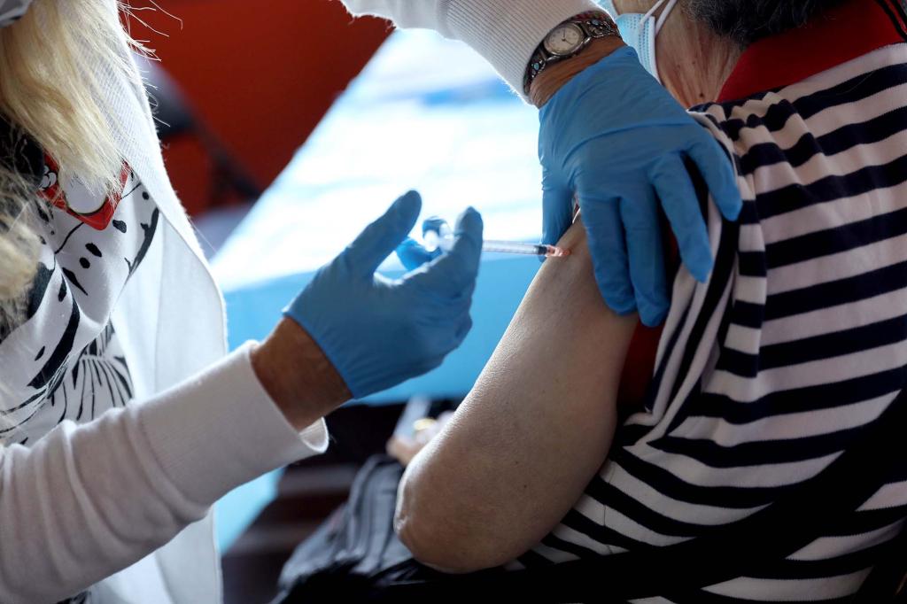 A healthcare worker administers the COVID-19 vaccine.