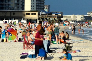 Beachgoers are shown on the coast at Gulf Shores, Ala., on Thursday, Aug. 12, 2021.