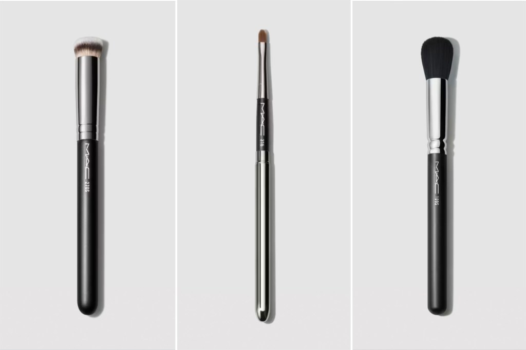 Three black and silver makeup brushes on gray background