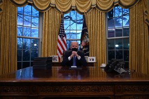 US President Joe Biden sits in the Oval Office at the White House in Washington, DC, after being sworn in at the US Capitol on January 20, 2021.