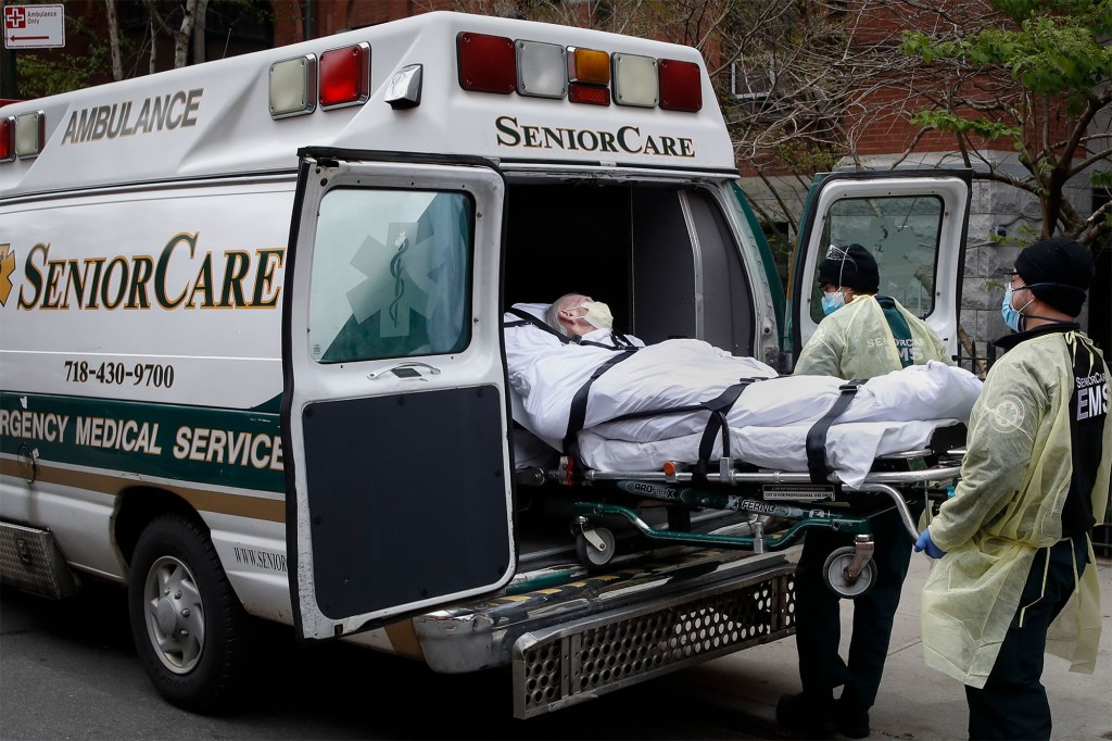 Apatient is loaded into an ambulance by emergency medical workers outside Cobble Hill Health Center in the Brooklyn borough of New York.