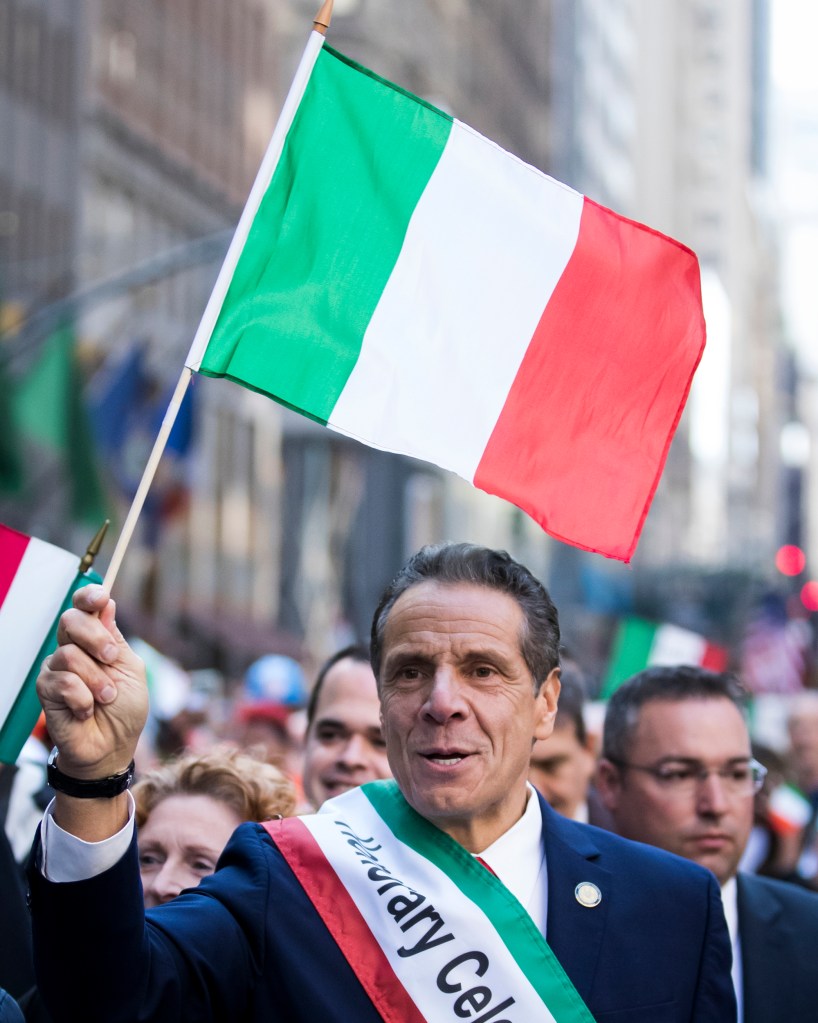 Governor Andrew Cuomo waves an Italian flag.