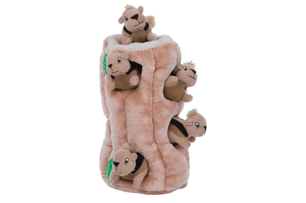 A stuffed animal tree trunk with stuffed squirrels inside 