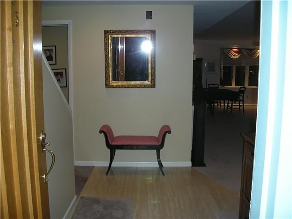 The foyer which leads to the stairs to the second floor.