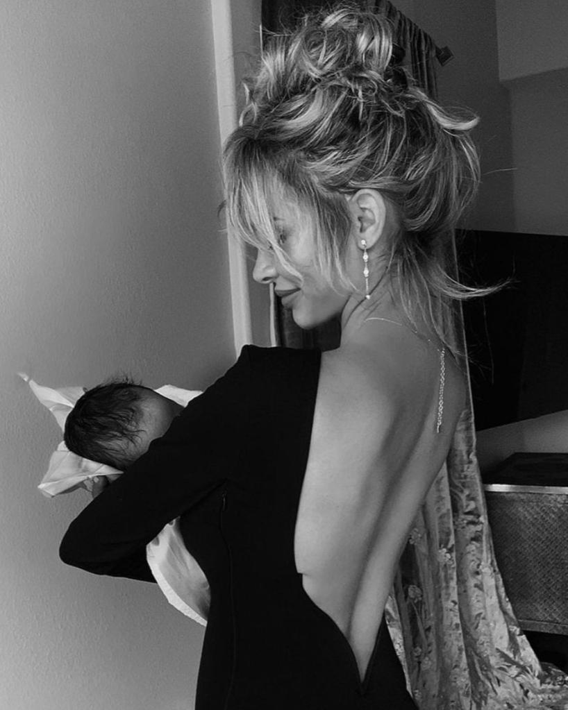 Scott cradling her and Cannon's newborn baby boy, Zen.