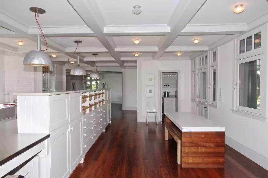 The chef's kitchen has coffered ceilings.