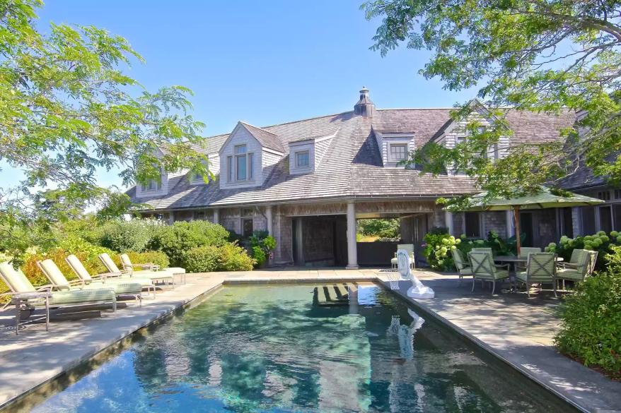 Outside, the home has a stone patio and a pool.