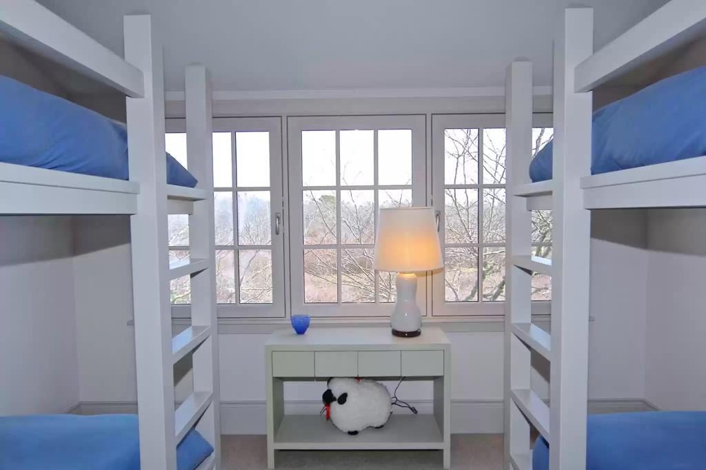 This bedroom is photographed with bunk beds.