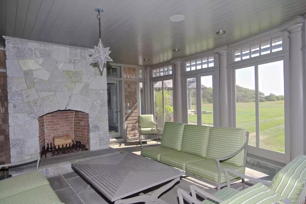 The screened-in porch has a fireplace. 