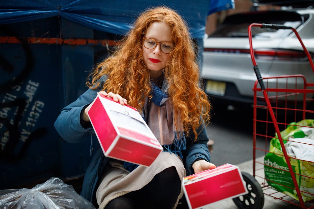 Sacks shows off some American Girl merchandise she found still in their boxes during a "trash walk."