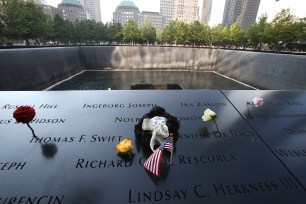 Flowers and a toy are placed to mourn the victims of the 9/11 terror attacks at the National September 11 Memorial and Museum.