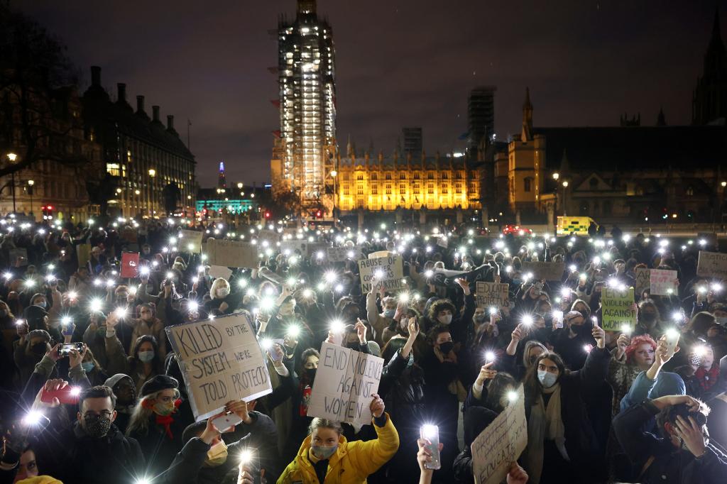 People flash lights from their mobile phones as they attend a protest at the Parliament Square, following the kidnap and murder of Sarah Everard, in London, Britain March 14, 2021. REUTERS/Henry Nicholls