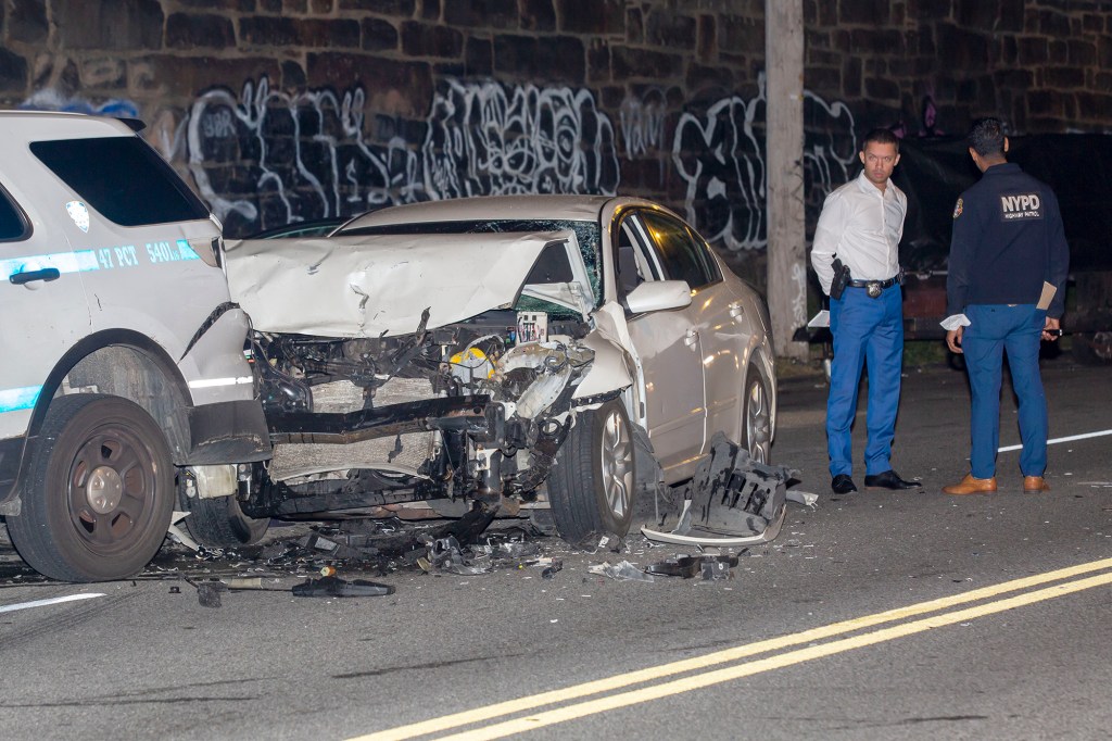 Police at the scene of a car accident where the driver allegedly hit 3 bicycle riders before crashing into an NYPD vehicle in the Bronx on September 14, 2021.