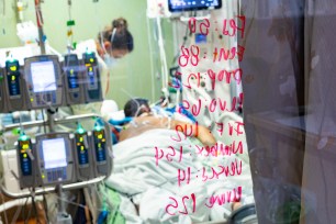 In this Aug. 31, 2021, file photo, Ann Enderle R.N. checks on a COVID-19 patient in the Medical Intensive care unit (MICU) at St. Luke's Boise Medical Center in Boise, Idaho.