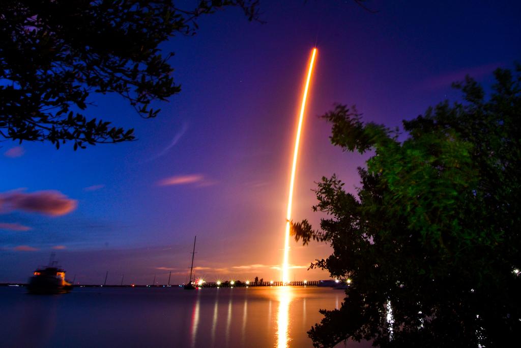 The launch of a SpaceX Crew Dragon capsule atop a Falcon 9 rocket is seen after taking off from Pad 39A at Kennedy Space Center in Cape Canaveral, Florida.