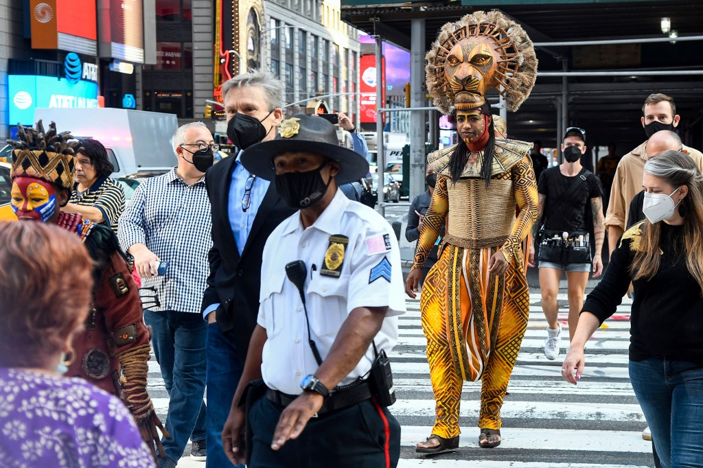 Costumed cast members of Broadway's "The Lion King," L. Steven Taylor, as Mufasa, right, and and Tshidi Manye, as Rafiki, left, appear in Times Square to herald the return of Broadway theater in New York, Tuesday, Sept. 14, 2021. 