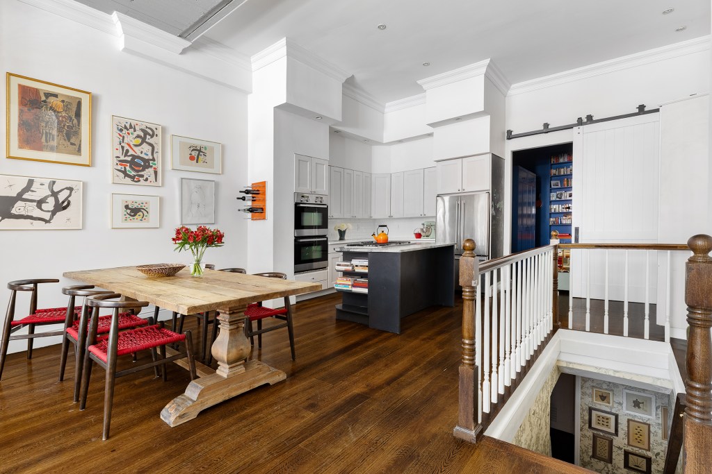 A view of the open floor plan which holds stairs that lead to the bedroom.