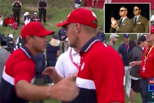 Brooks Koepka (left) and Bryson DeChambeau embrace after the US Ryder Cup victory.