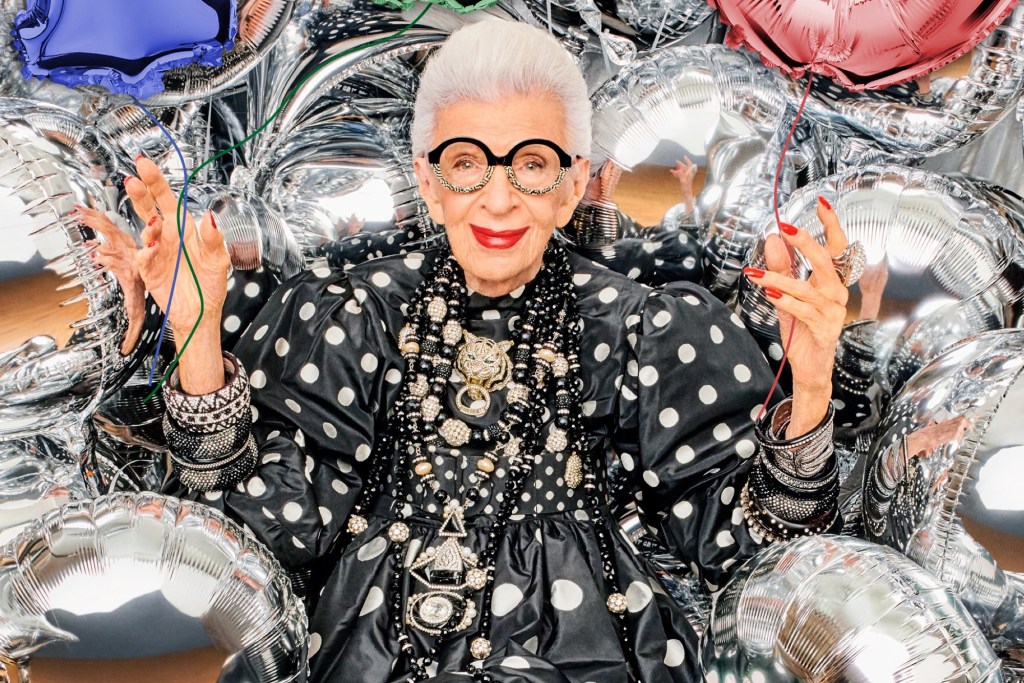 Iris Apfel wearing necklaces and a polka dot dress