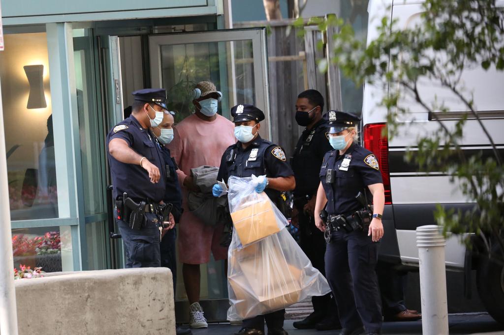 NYPD officers carrying evidence out of Williams' building.