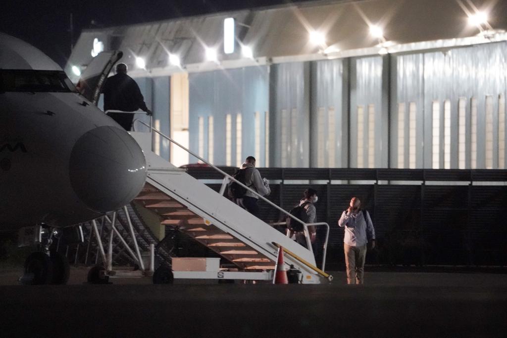 Some immigrants are spotted getting off a World Atlantic Airlines plane at Westchester County Airport.