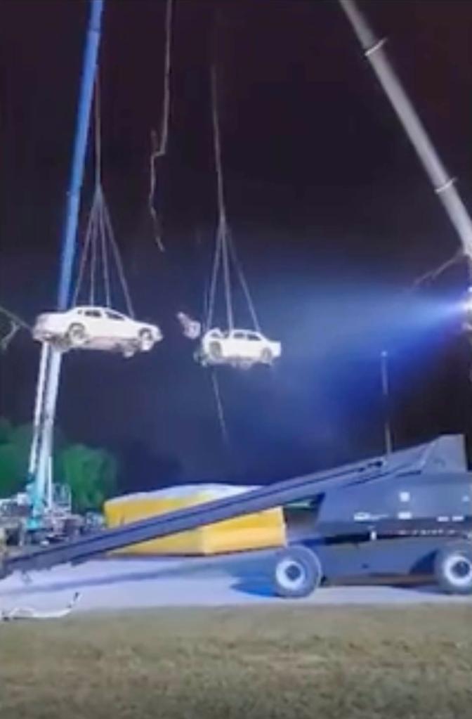 Jonathan Goodwin hangs suspended in the air between two cars, also suspended, shortly before they collide in a horrific stunt gone wrong.