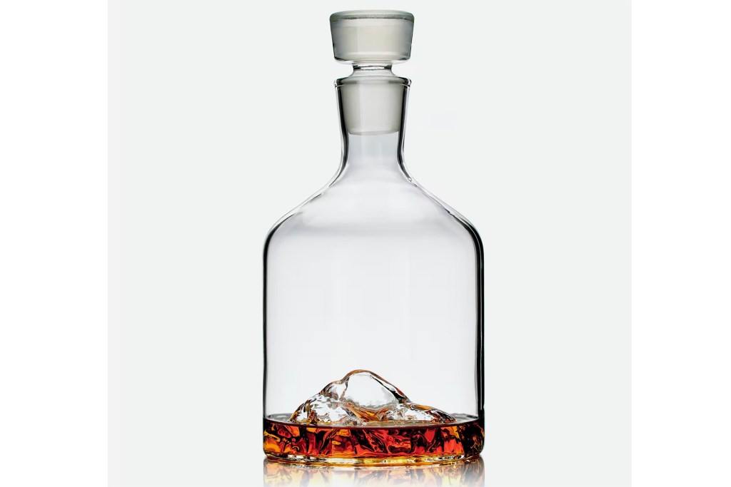 A whiskey decanter with a mountain at the bottom