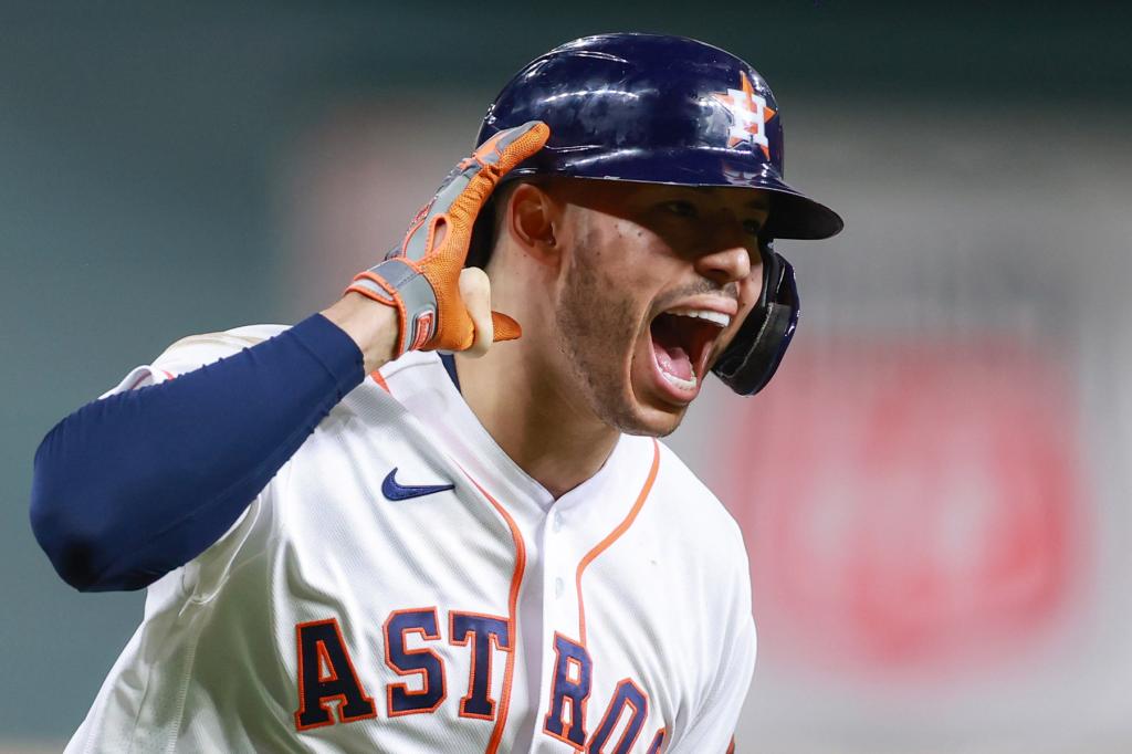 Carlos Correa #1 of the Houston Astros reacts to hitting a solo home run during the seventh inning against the Boston Red Sox during Game One of the American League Championship Series at Minute Maid Park on October 15, 2021 in Houston, Texas.