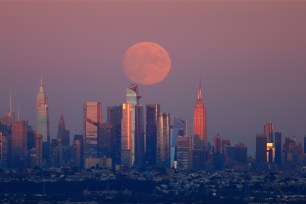 A full Harvest Moon graces Midtown Manhattan in September 2021.